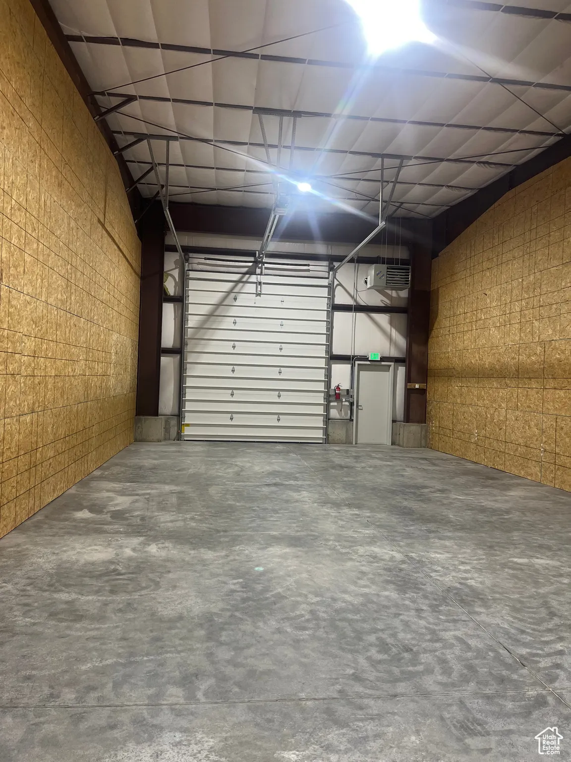 Garage featuring a heating unit