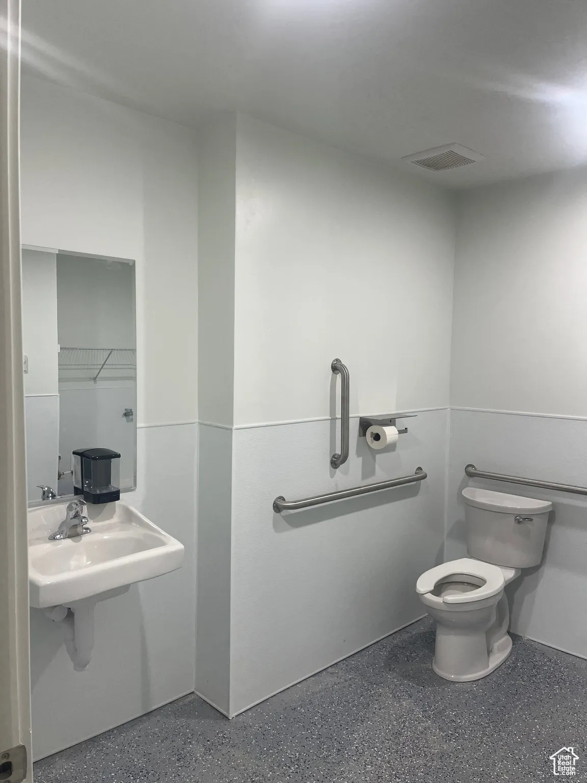 Bathroom featuring toilet and a closet