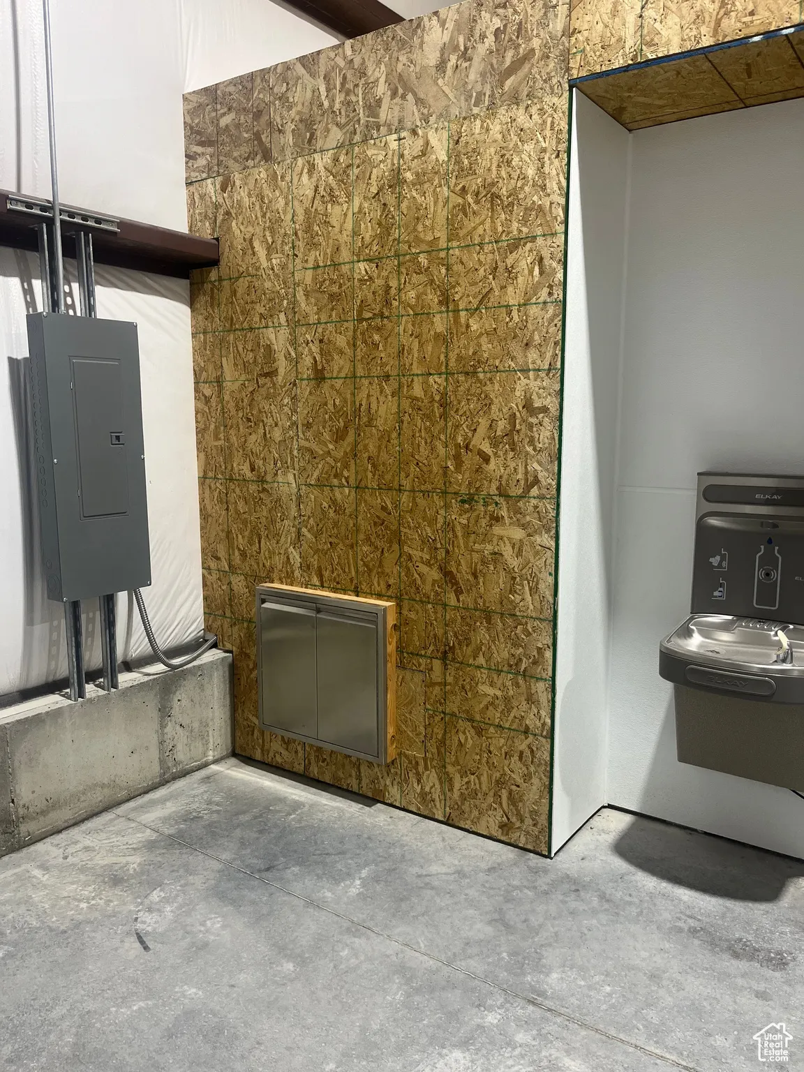 Detailed view of concrete flooring and electric panel