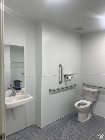 Bathroom featuring toilet and a closet