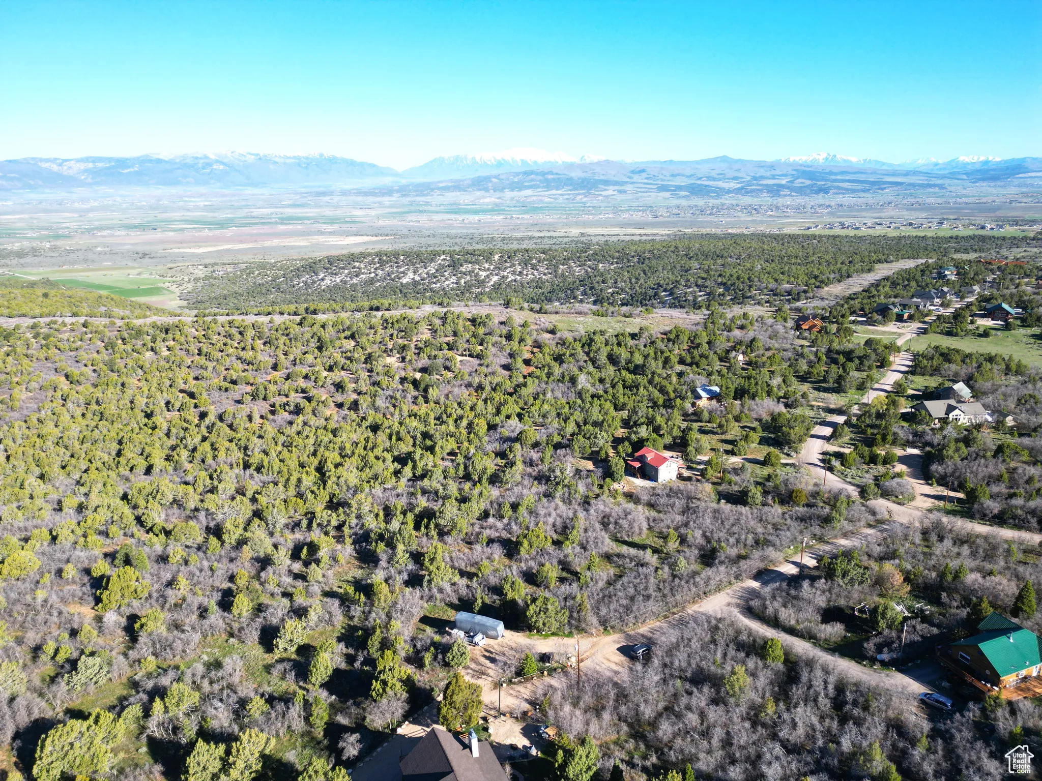 Aerial view of property and surrounding area featuring mountains
