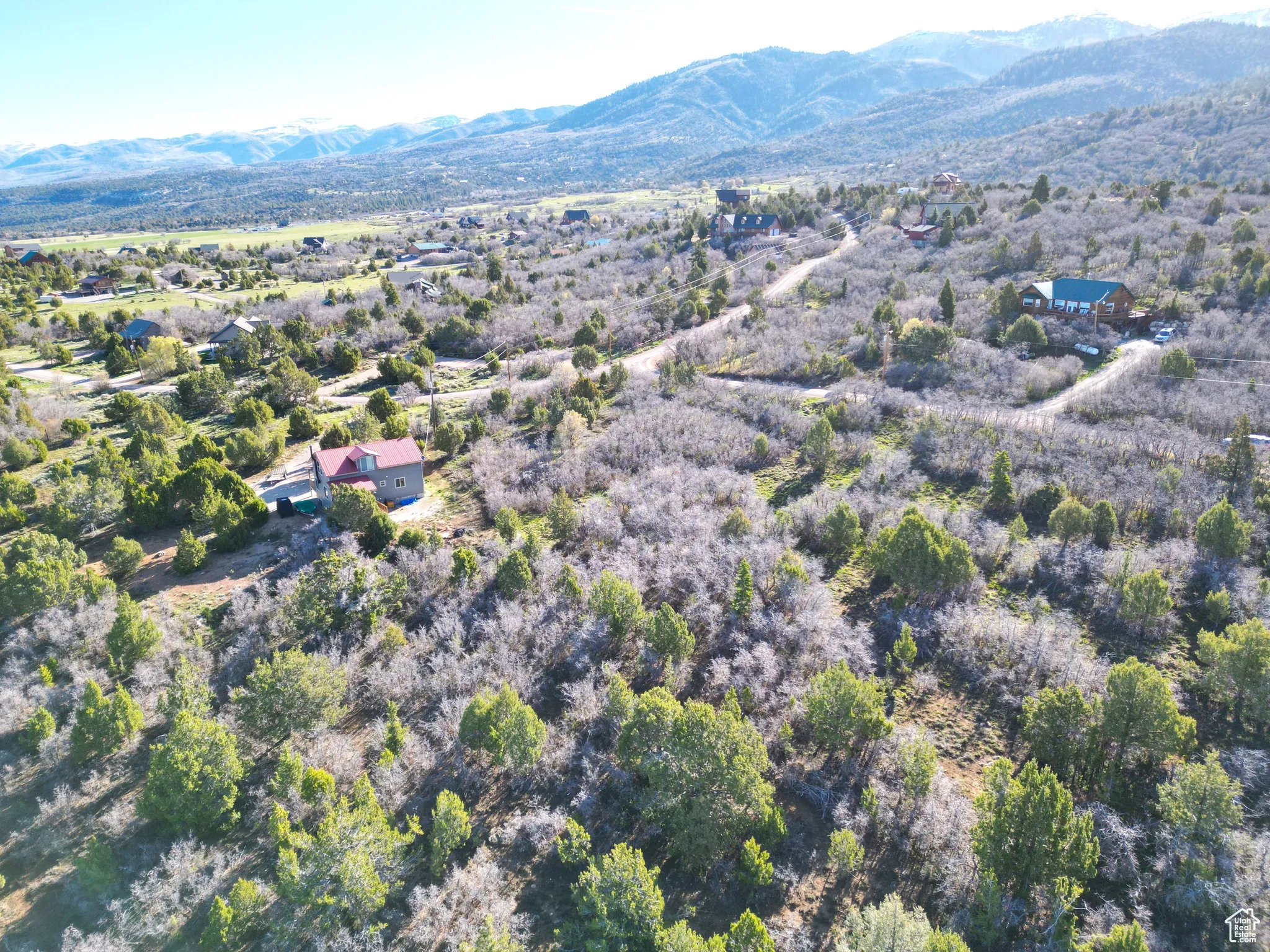 Aerial view of property's location with a mountainous background