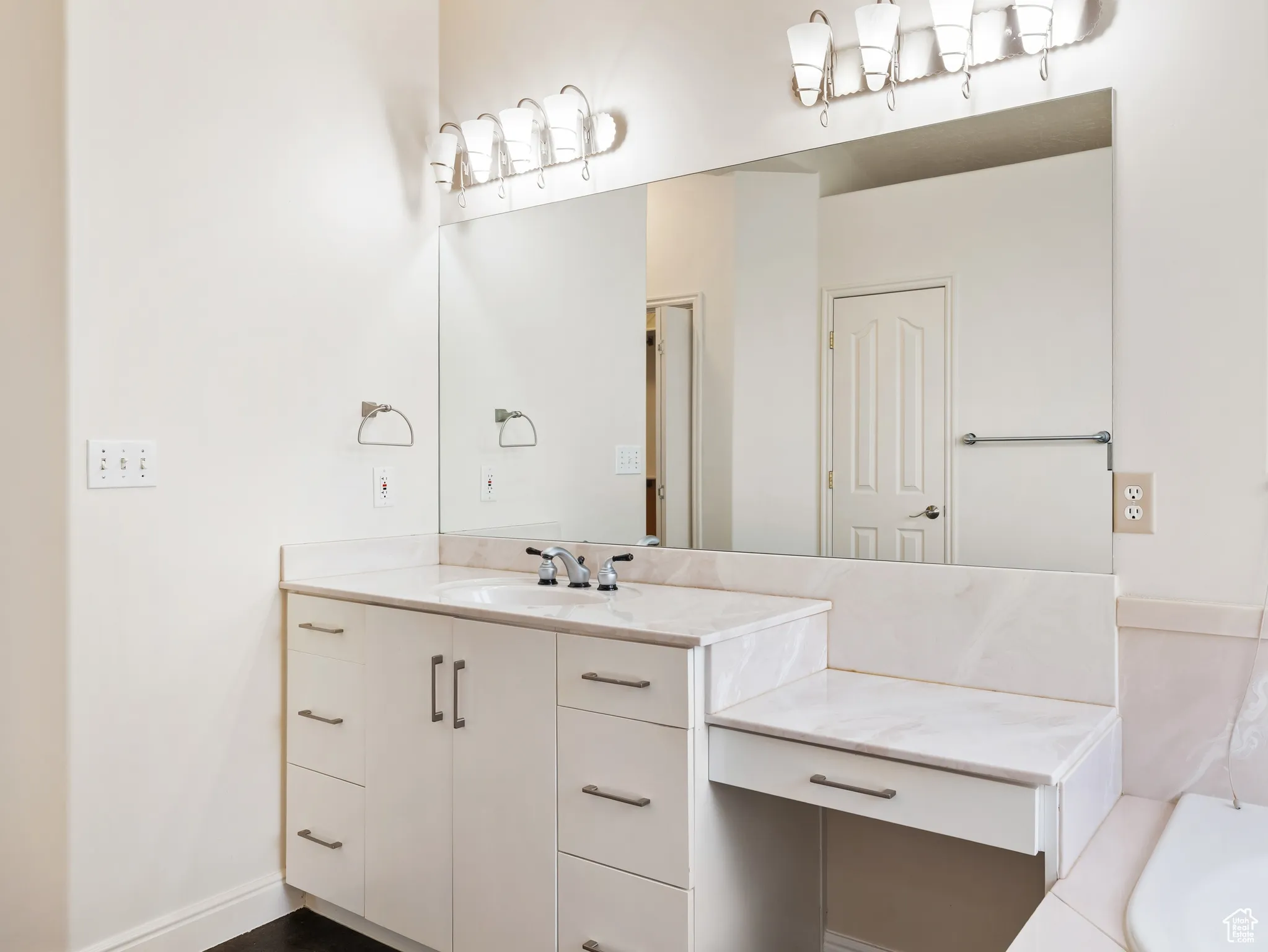 Bathroom with vanity and a bath