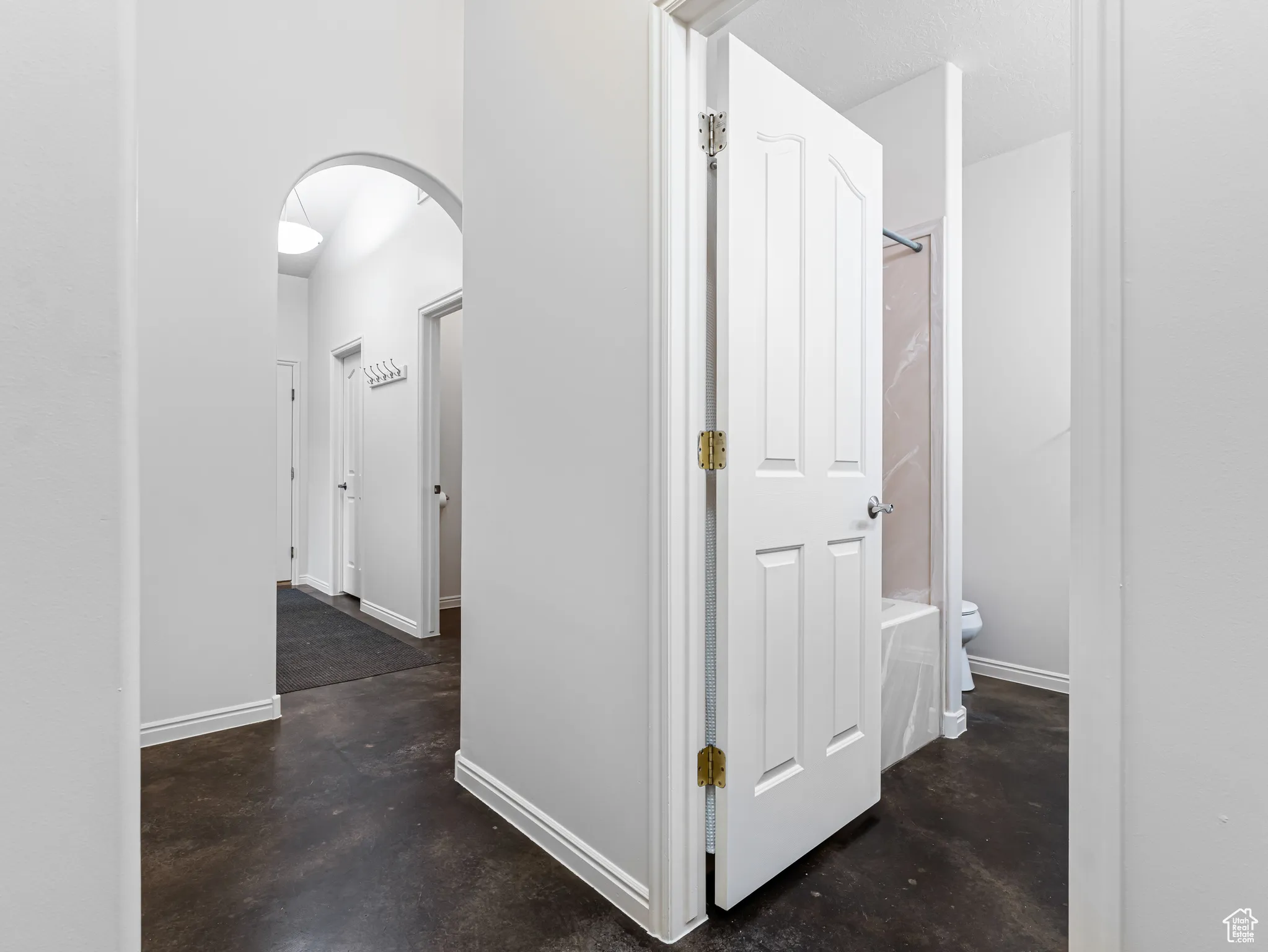 Corridor with arched walkways and finished concrete floors