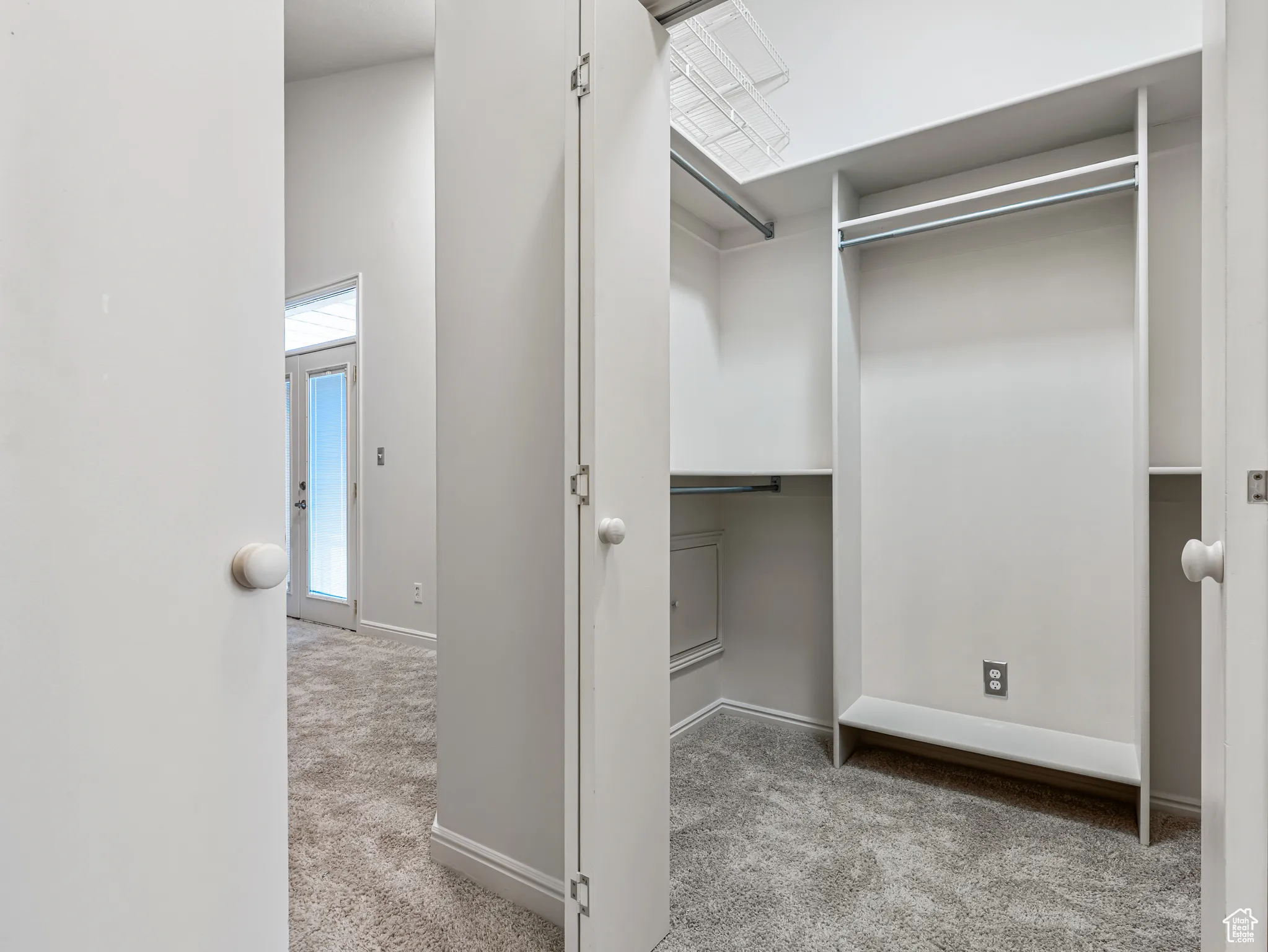 Two Separate Walk in Closets opposite each other with Organizers