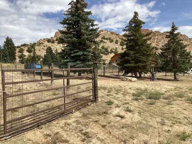 Gate featuring a mountain view and a view of countryside