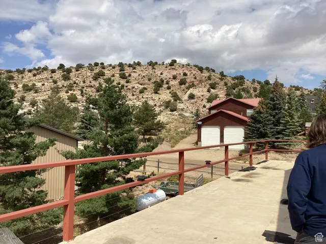View of patio with an outbuilding and a mountain view
