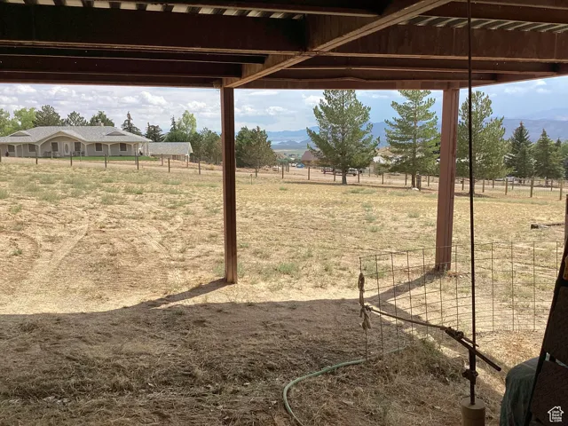 View of yard with a mountain view, a rural view, and a pergola