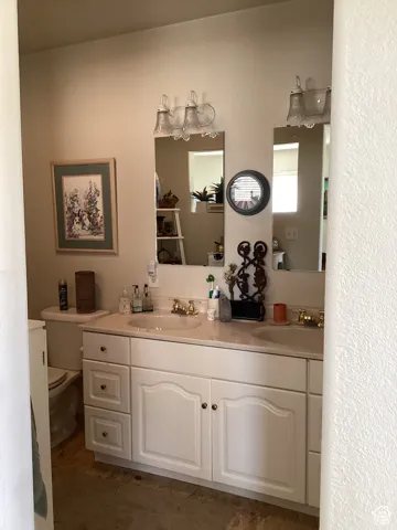 Bathroom with double vanity and toilet
