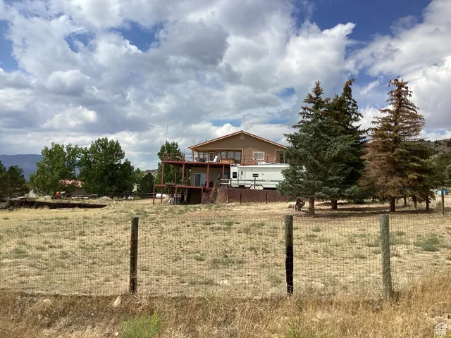 View of yard with a deck and stairs