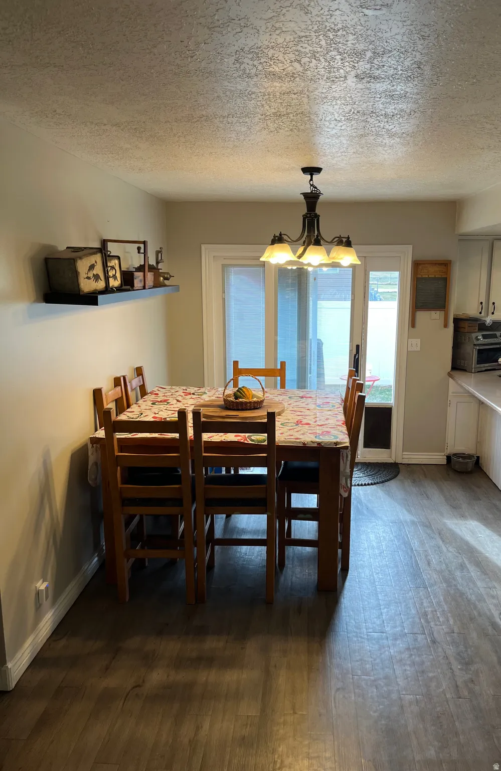 Dining area featuring a textured ceiling and dark wood finished floors
