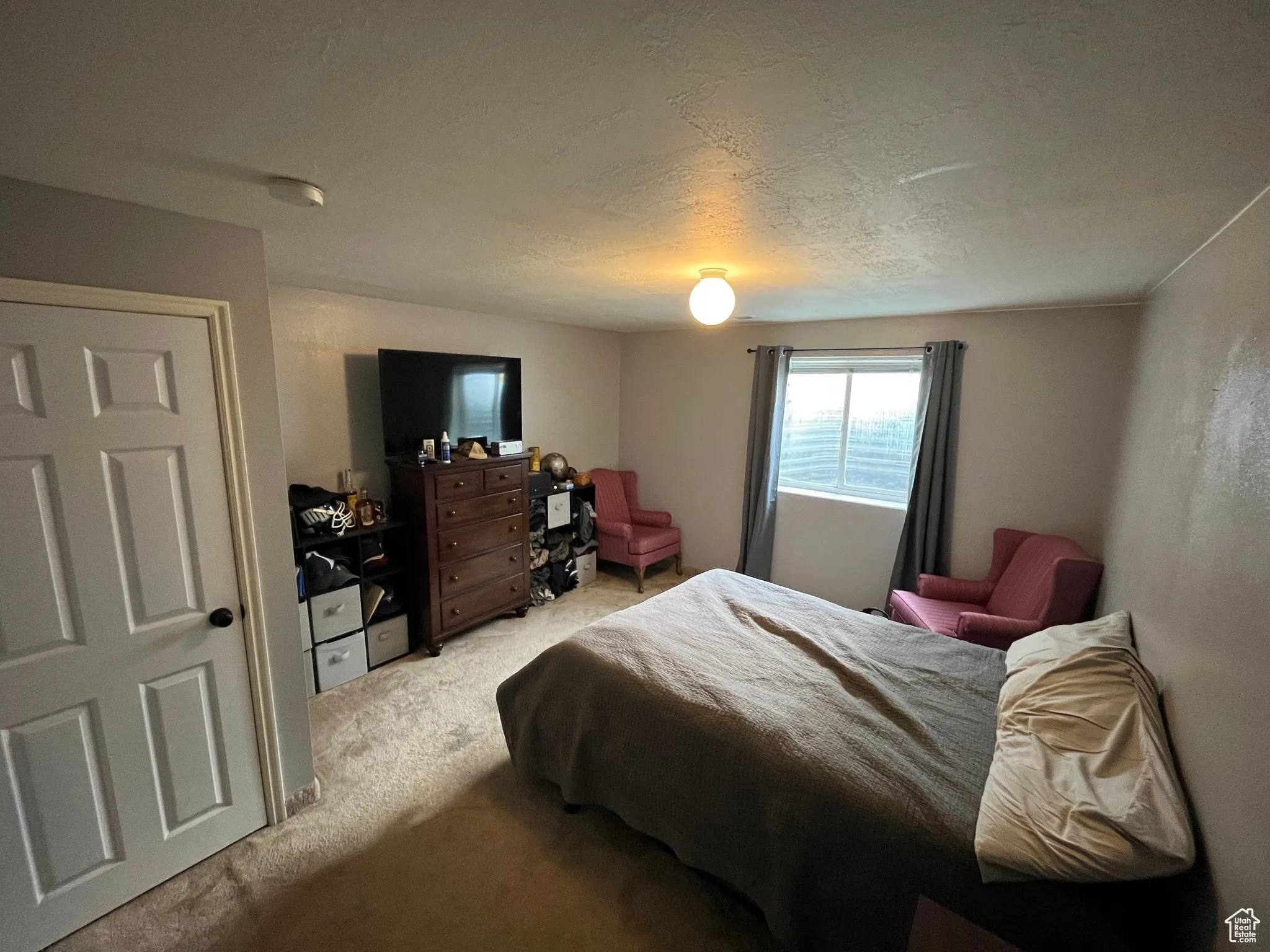 Bedroom featuring carpet flooring and a textured ceiling