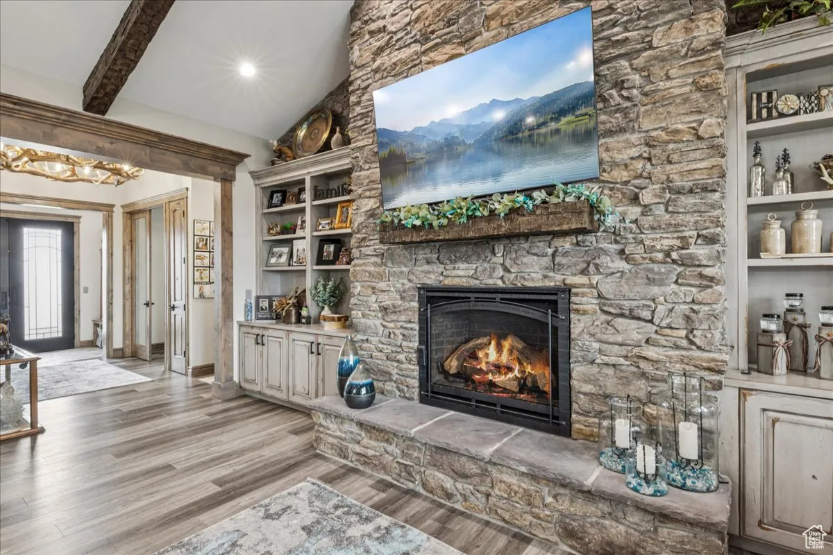 Living room featuring a fireplace, light wood finished floors, and recessed lighting