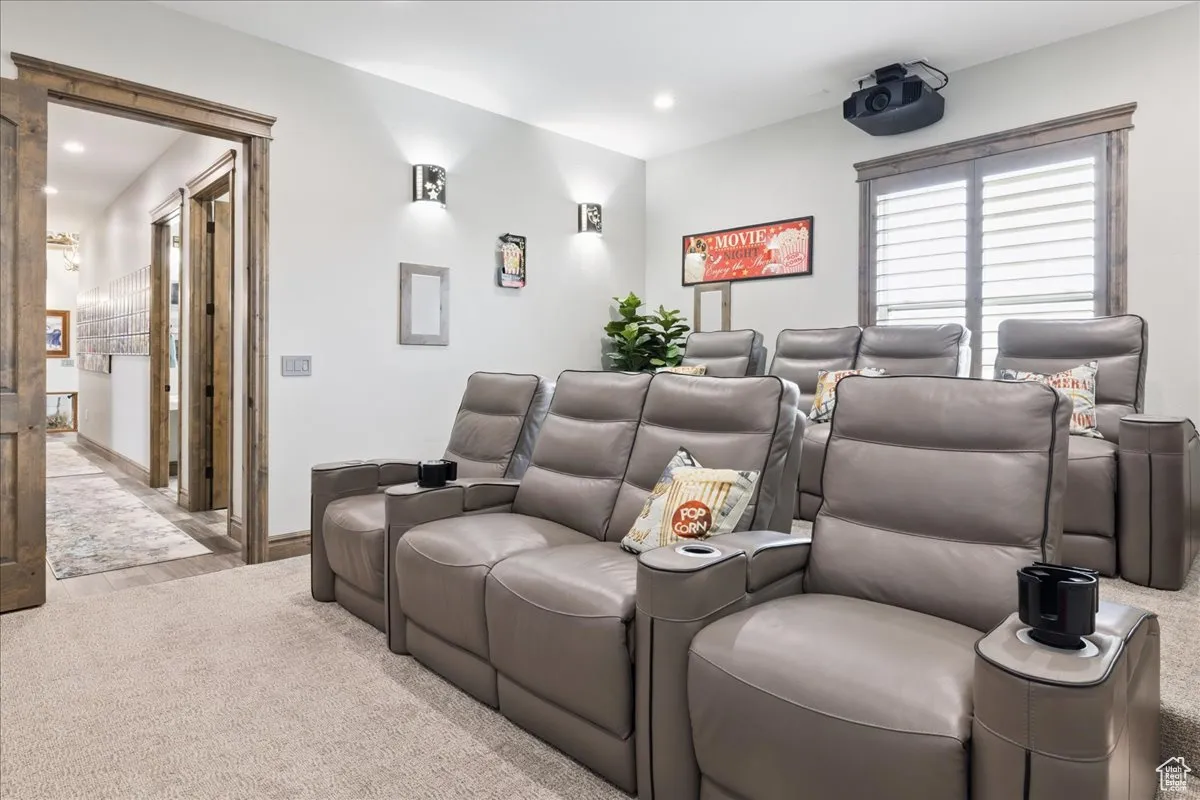 Home theater room with recessed lighting and carpet