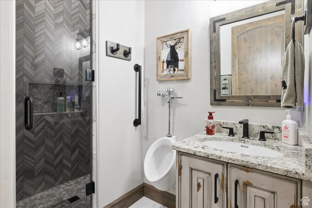 Bathroom featuring a stall shower and vanity