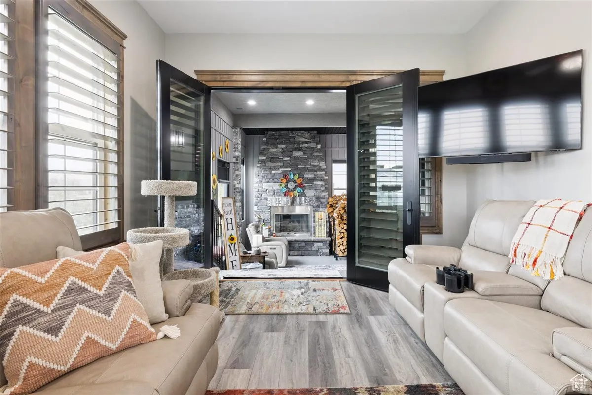 Living area featuring a stone fireplace and wood finished floors