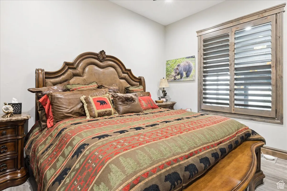 Bedroom with wood finished floors and ceiling fan