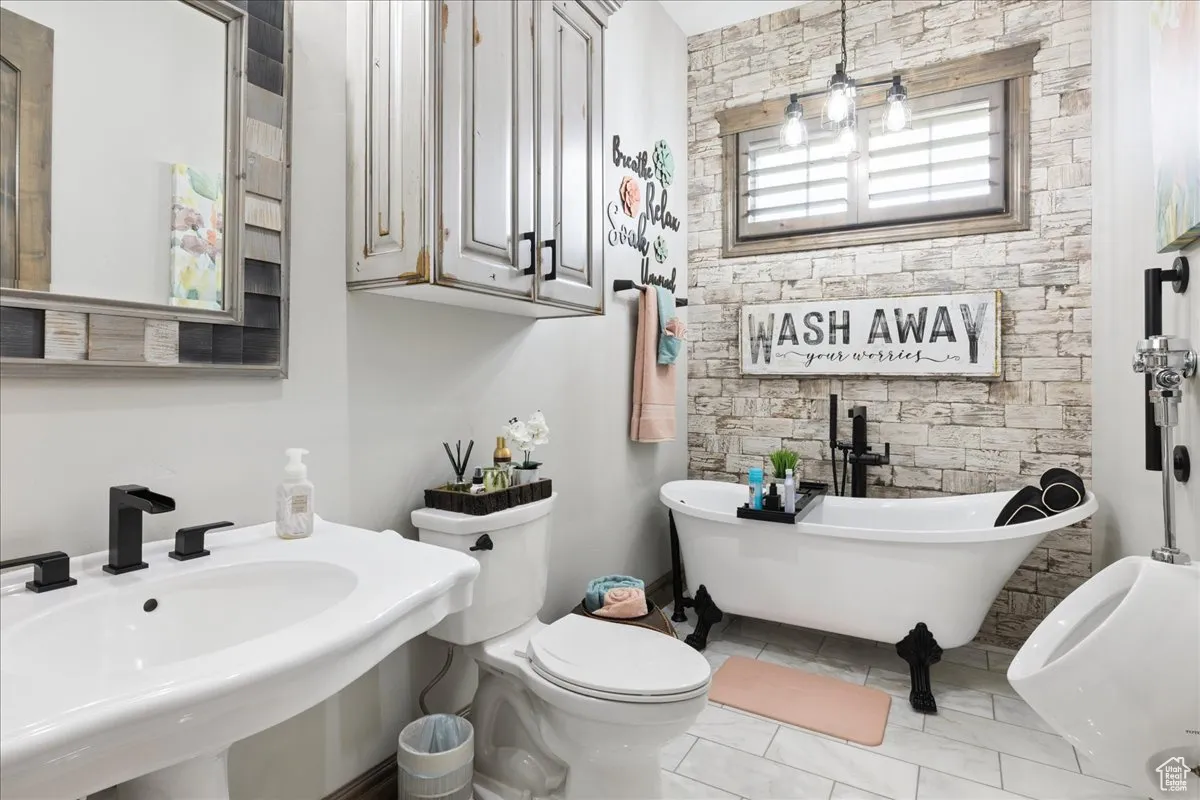 Bathroom with a freestanding bath and tile patterned flooring