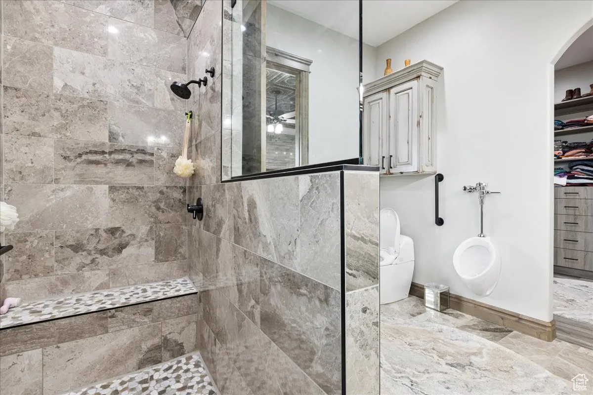 Full bathroom with a walk in shower and a spacious closet