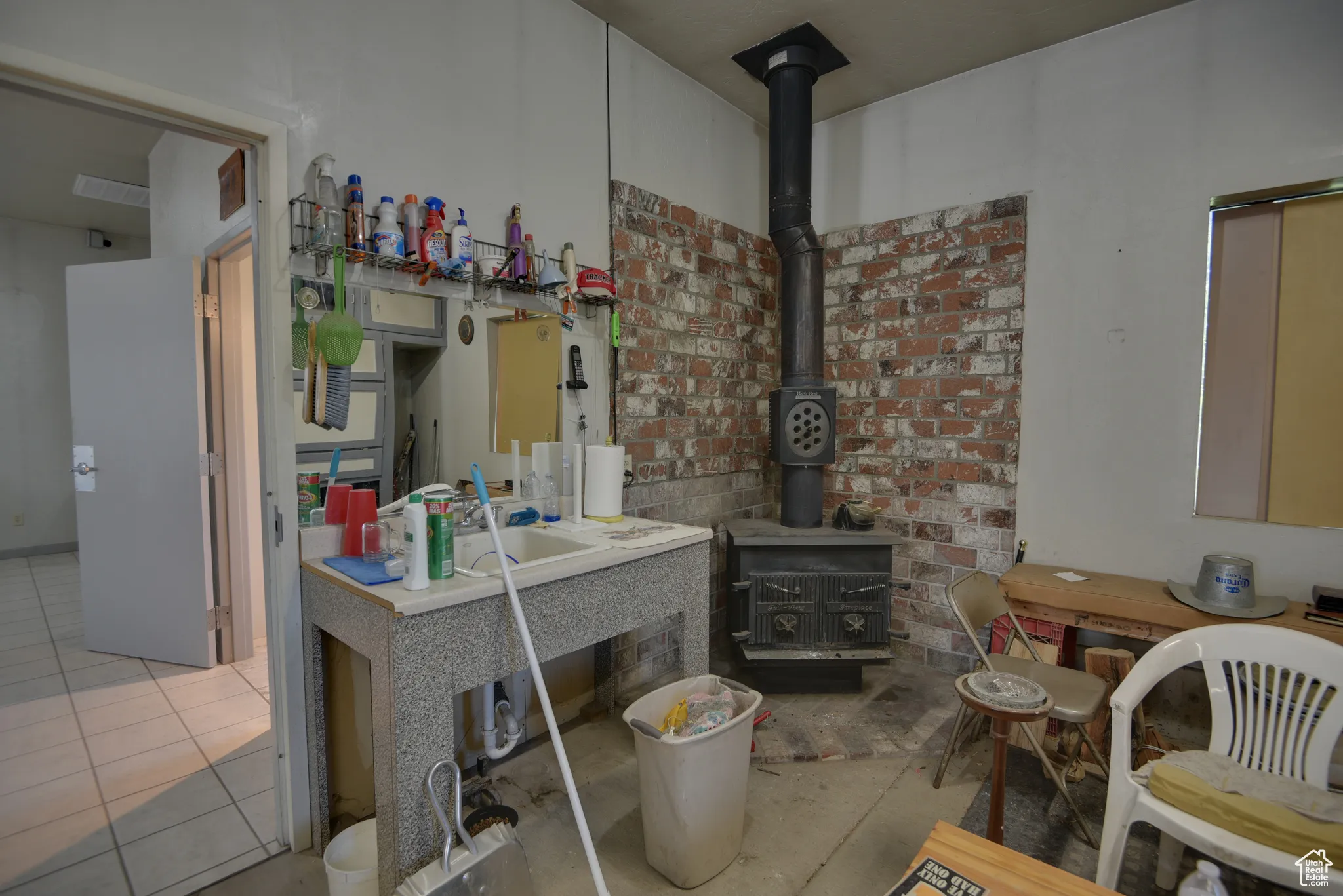 Kitchen featuring a wood stove and tile patterned flooring