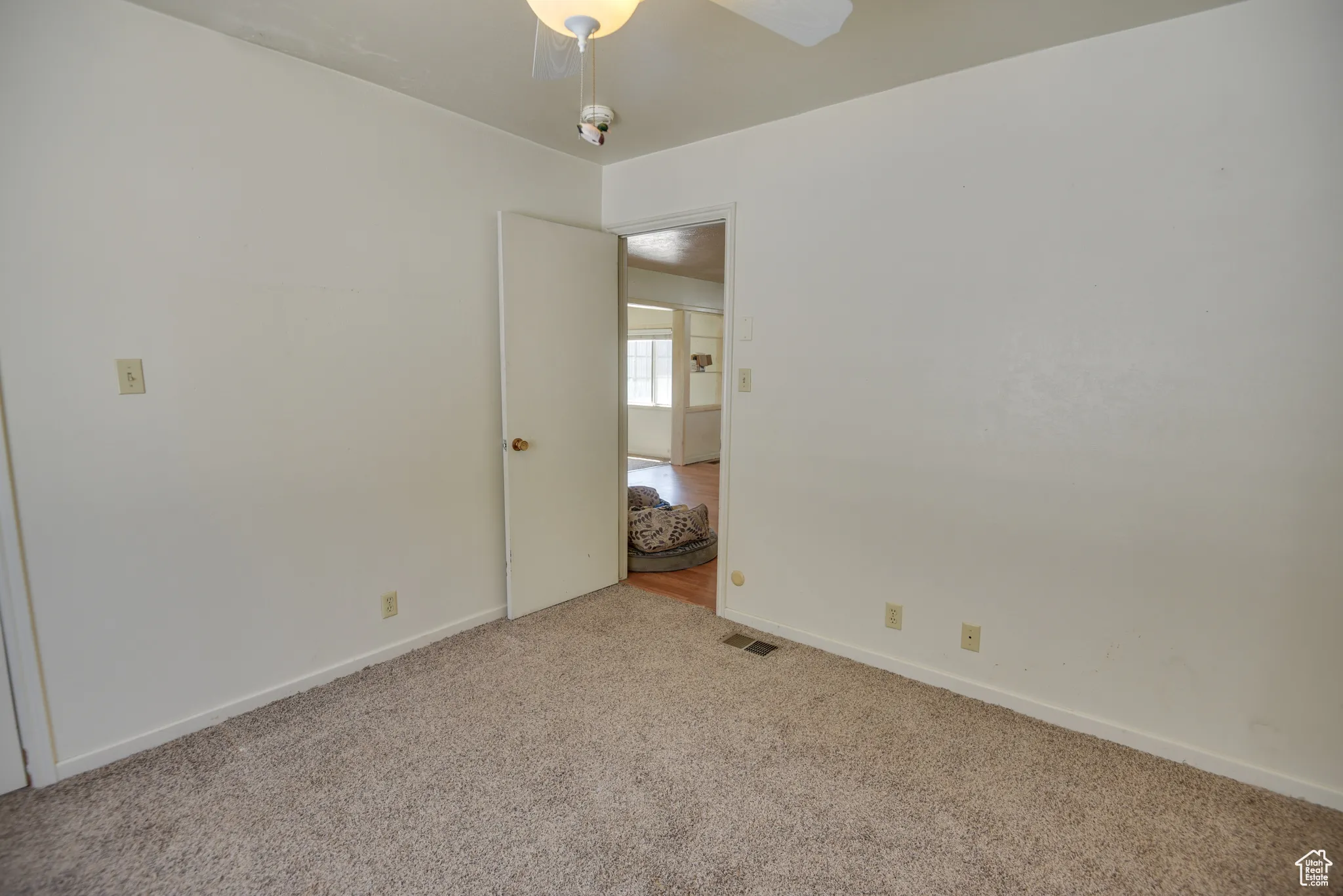 Unfurnished room with carpet and baseboards