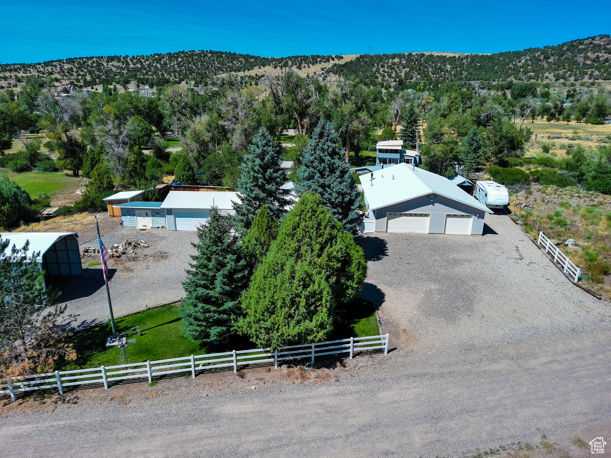 View from above of property featuring a heavily wooded area and a mountainous background