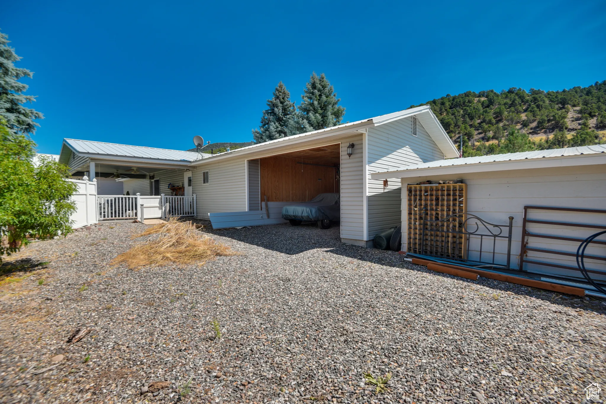 Rear view of house featuring a metal roof and ceiling fan