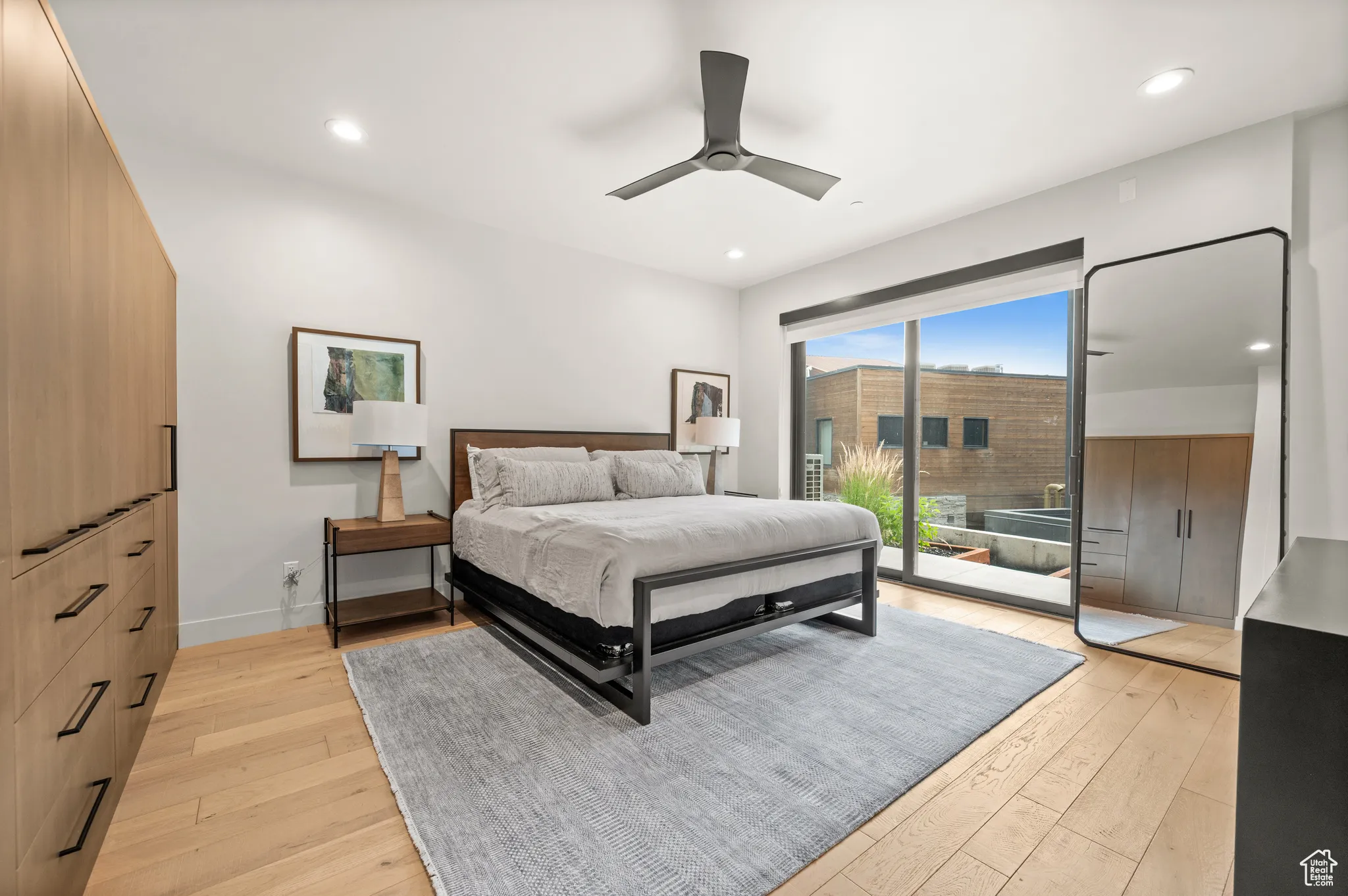 Downstairs, in the primary bedroom, sliding doors walk out to a quiet patio.