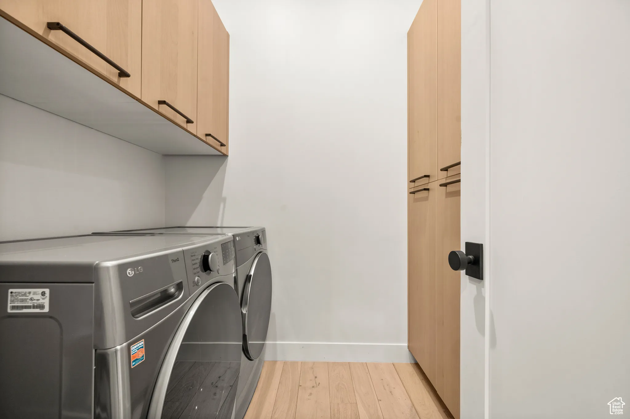 Laundry room equipped with full size washer and dryer and lots of storage space