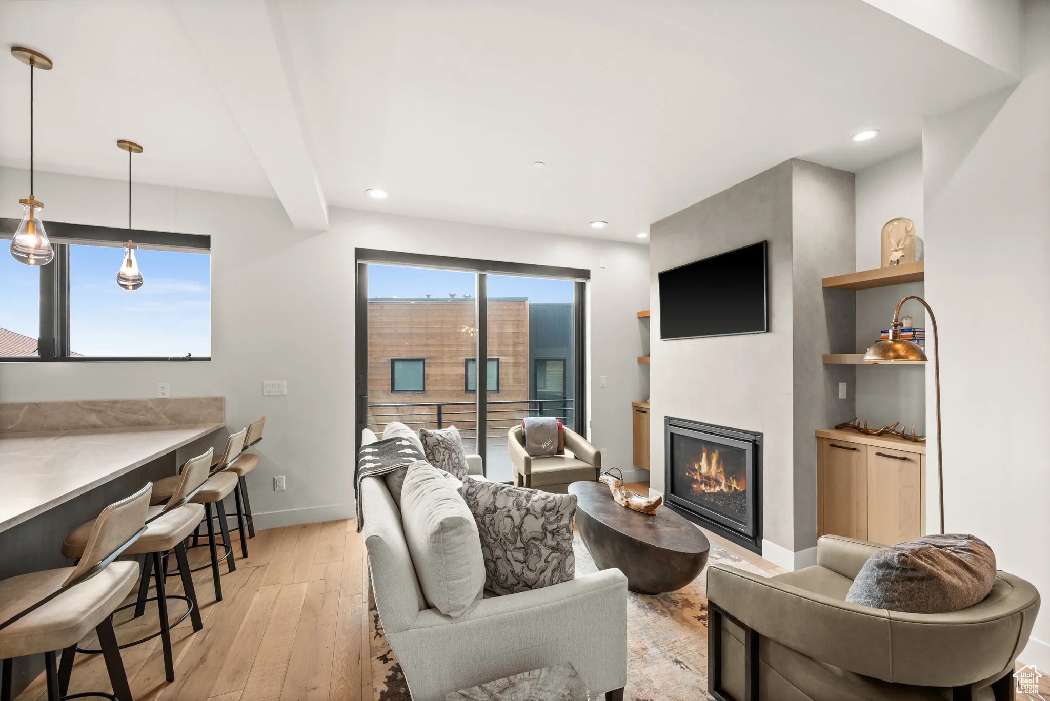 Within the great room sits this cozy family room with its warm fireplace, mounted T.V. and built-ins.