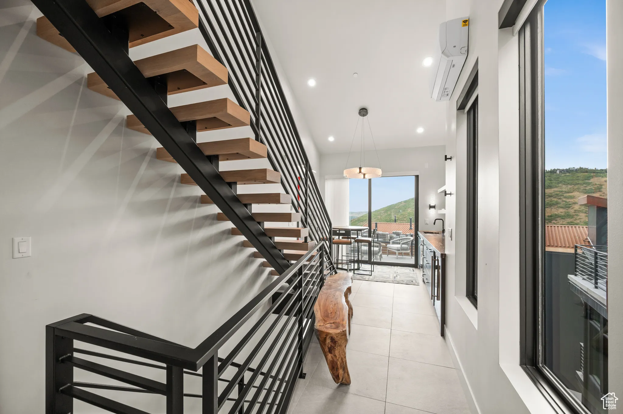 Upon entering the home, one is struck with the beauty of the hillside captured in the view.