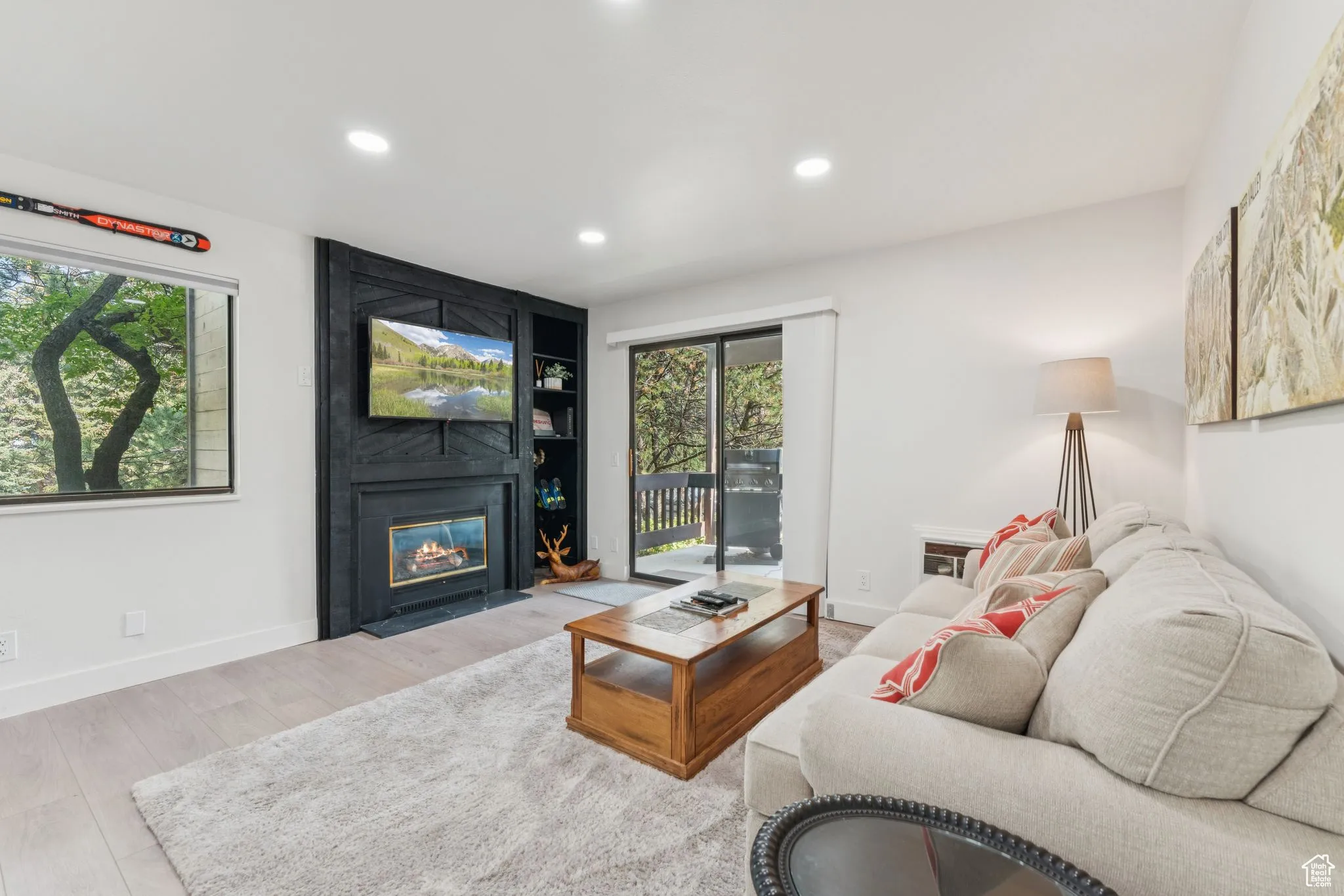 Living area with a fireplace, recessed lighting, and wood finished floors