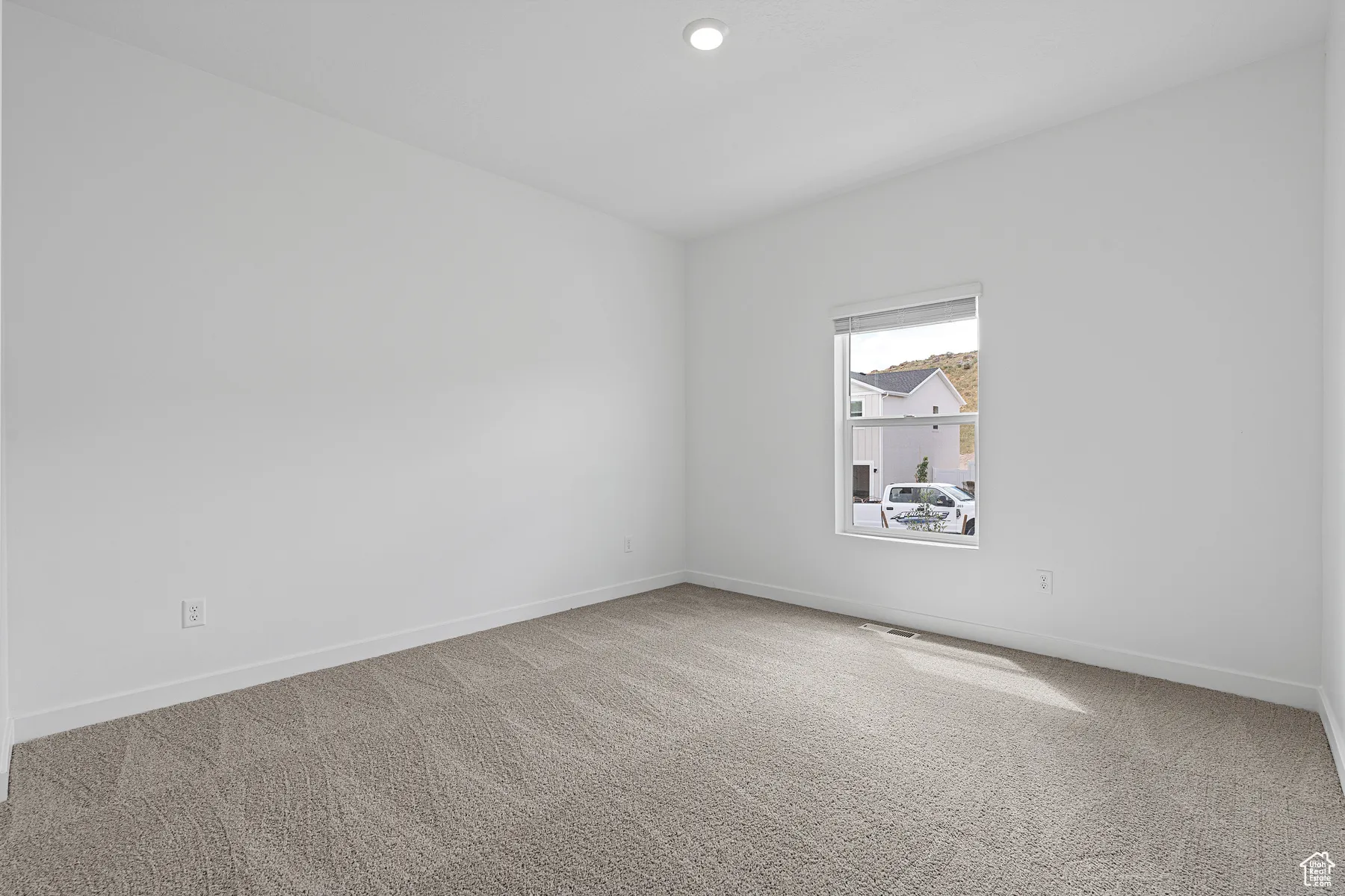 Spare room featuring carpet floors and recessed lighting