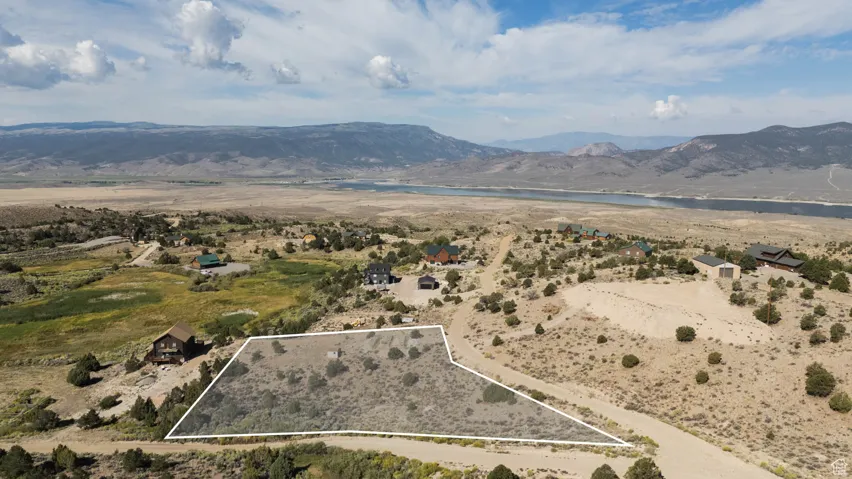 Aerial view of property's location with property boundaries highlighted and a water and mountain view
