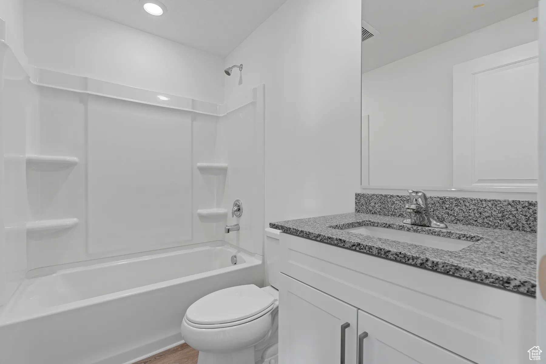 Bathroom featuring  shower combination, vanity, and recessed lighting