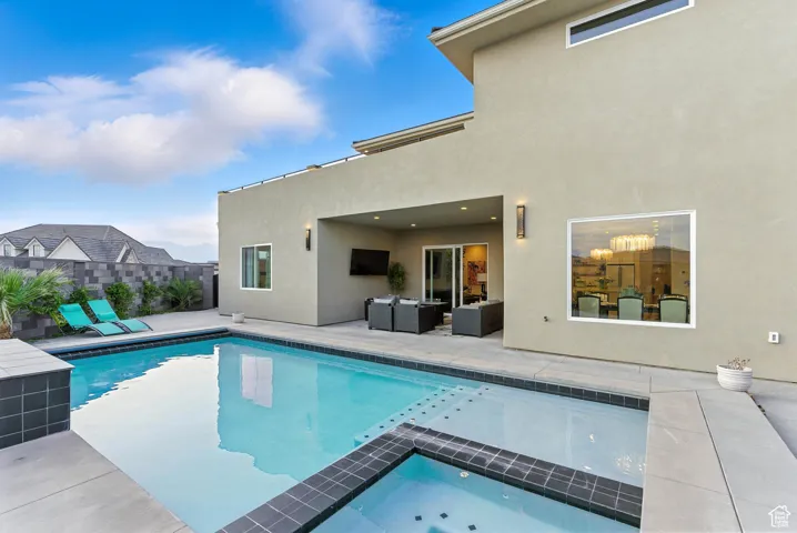 View of pool featuring a patio area and a pool with connected hot tub