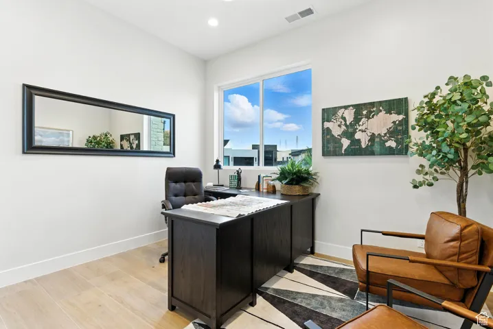 Office featuring light wood-type flooring and recessed lighting could be a 4th bedroom.