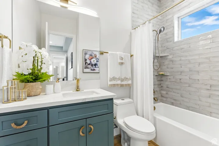 Full bathroom featuring vanity and shower / tub combo with curtain