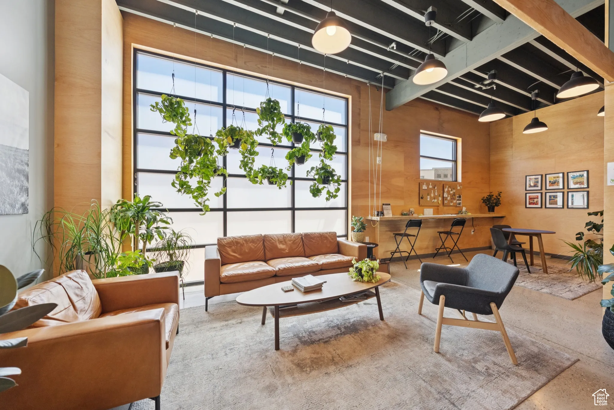 Common area with wood walls and a towering ceiling