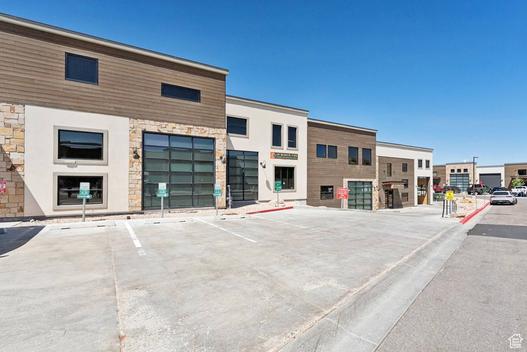 View of commercial property with uncovered parking
