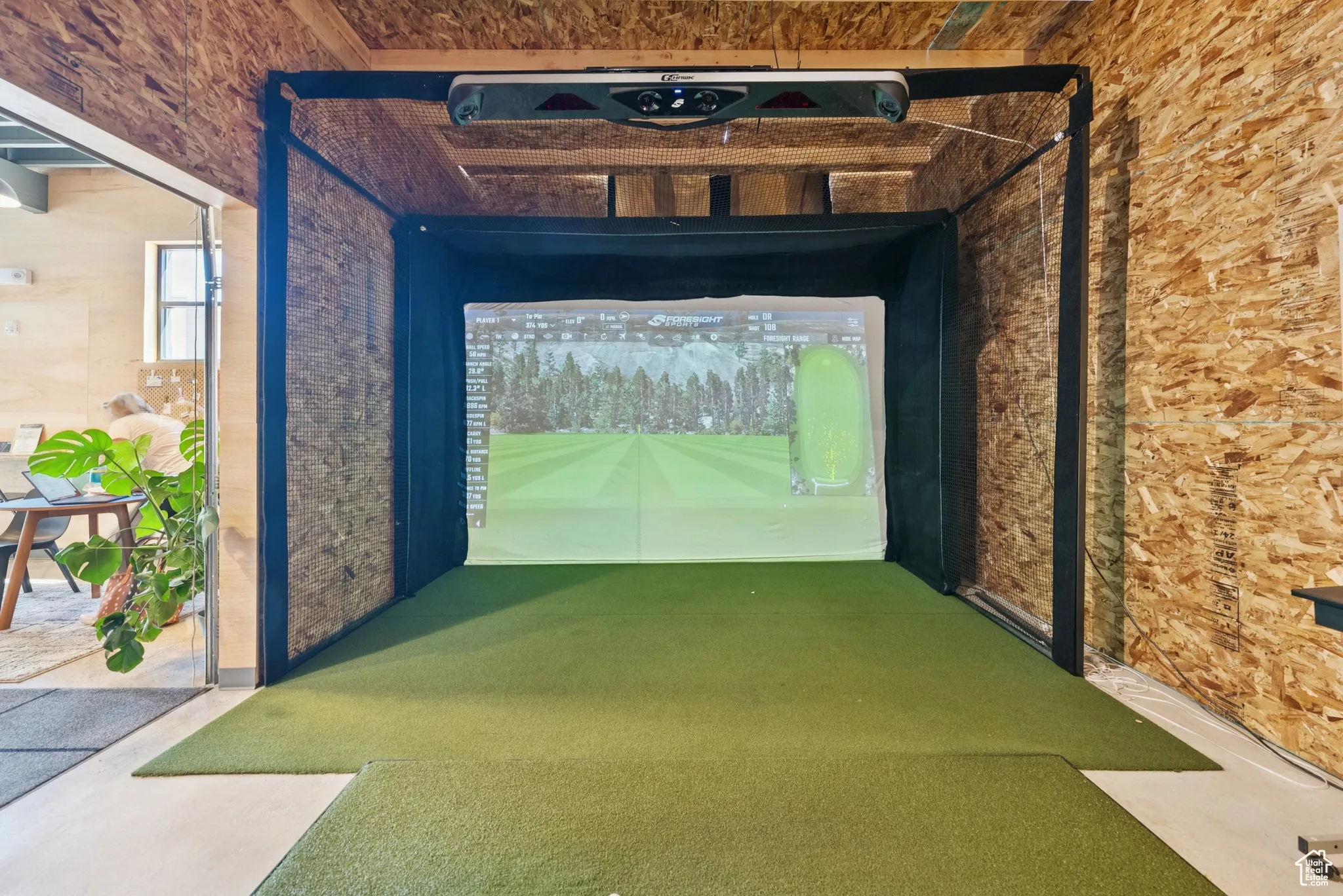 Playroom featuring golf simulator and carpet floors