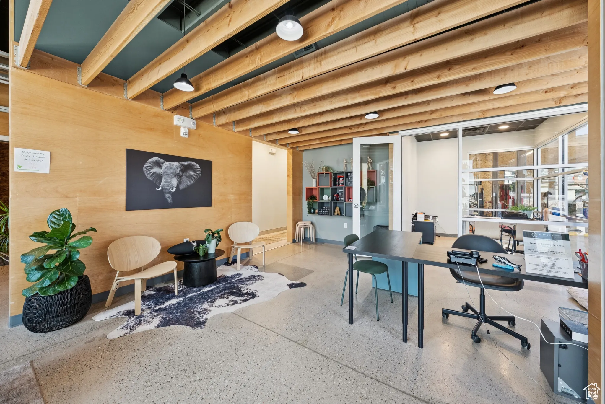 Office with speckled floor and wood walls
