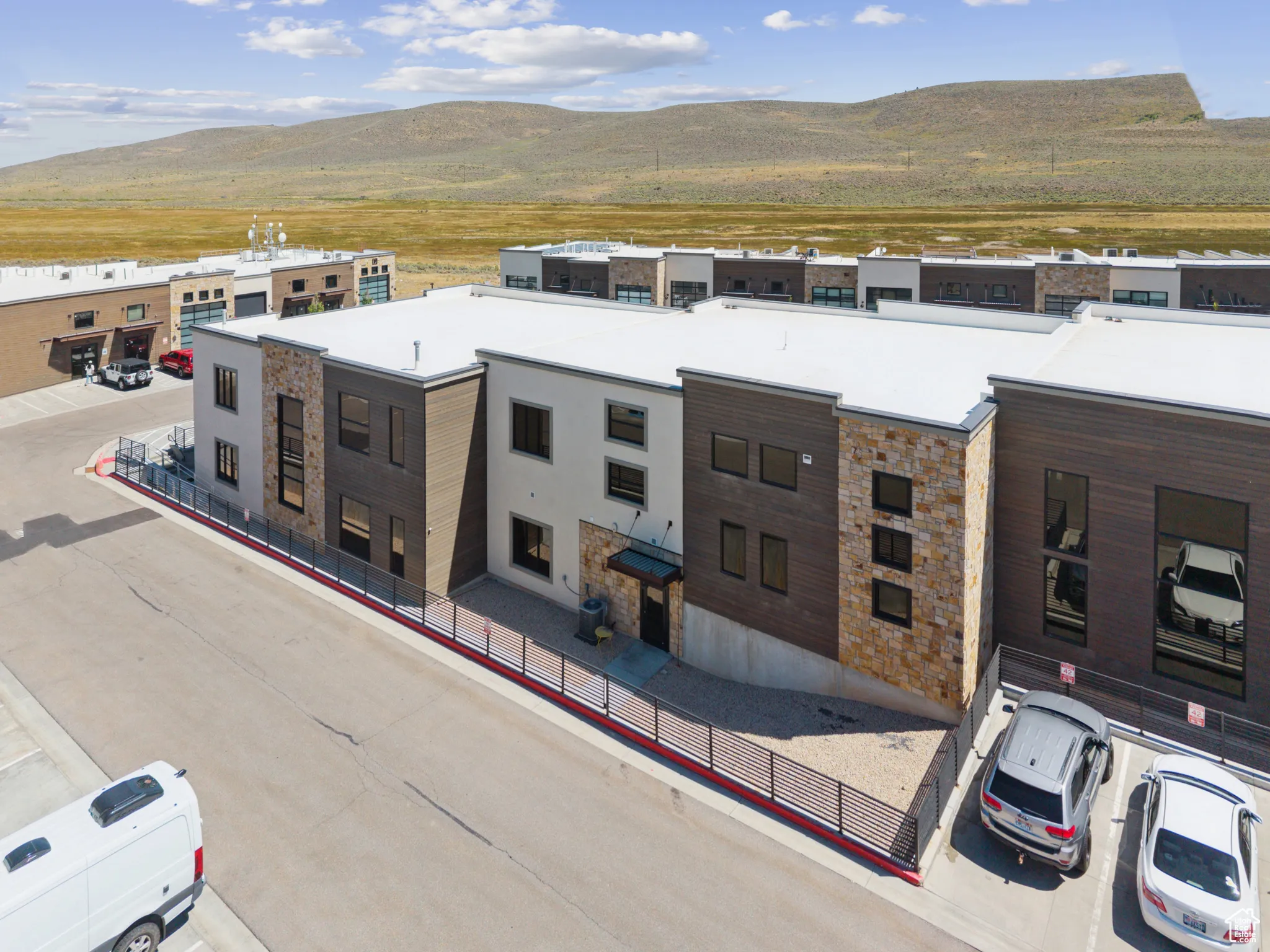 Contemporary home featuring a mountain view and stone siding