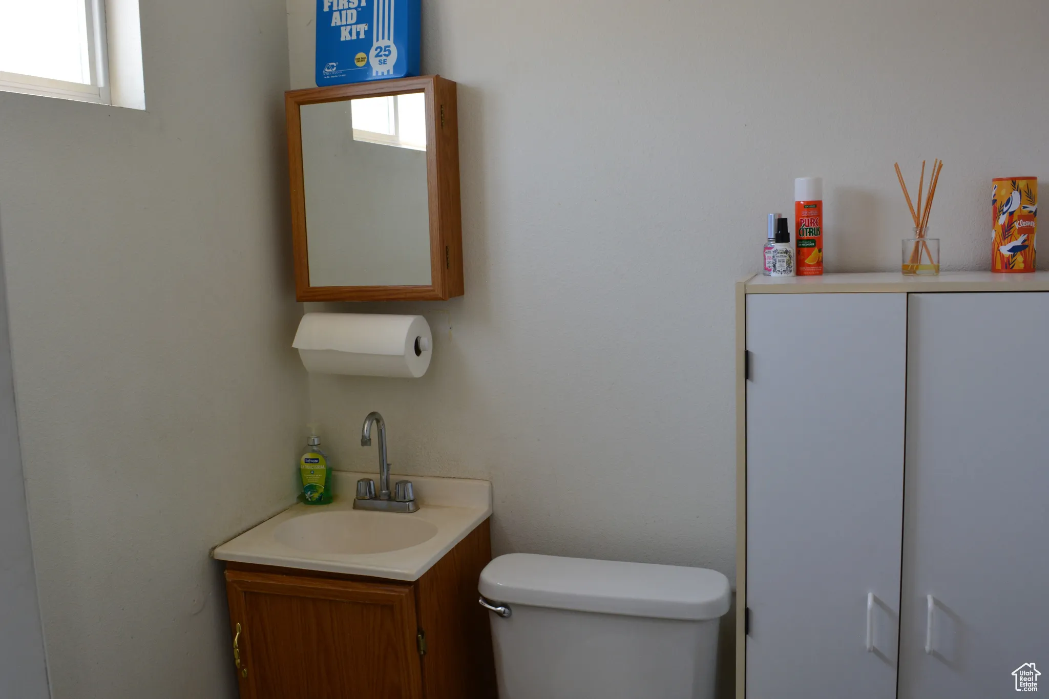 Half bathroom featuring toilet and vanity