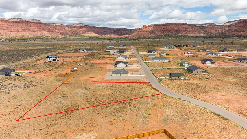 Aerial overview of property's location featuring property boundaries highlighted and a mountain backdrop
