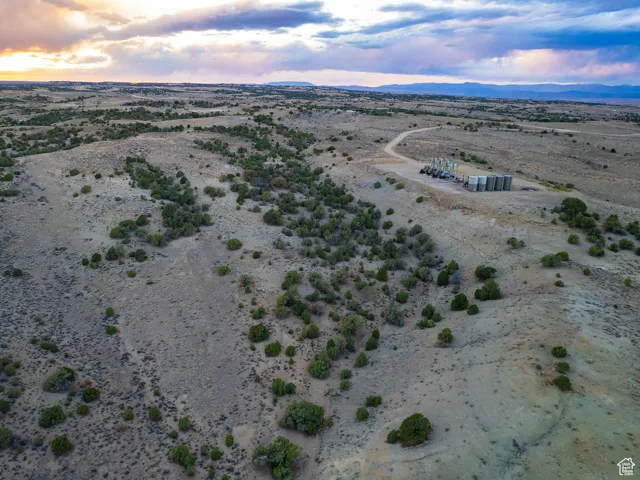 Aerial view of sparsely populated area featuring a desert landscape and a mountainous background
