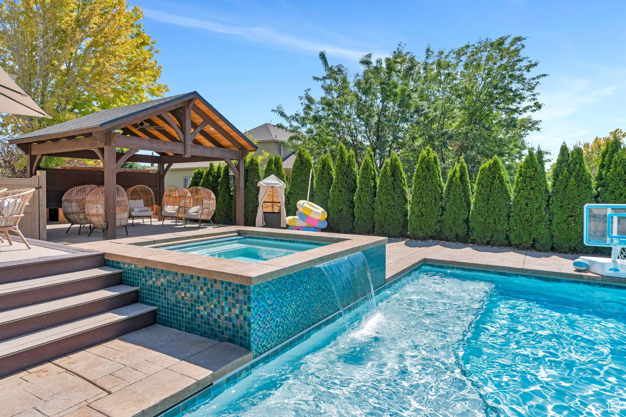 View of swimming pool featuring a pool with connected hot tub, a patio, and a gazebo