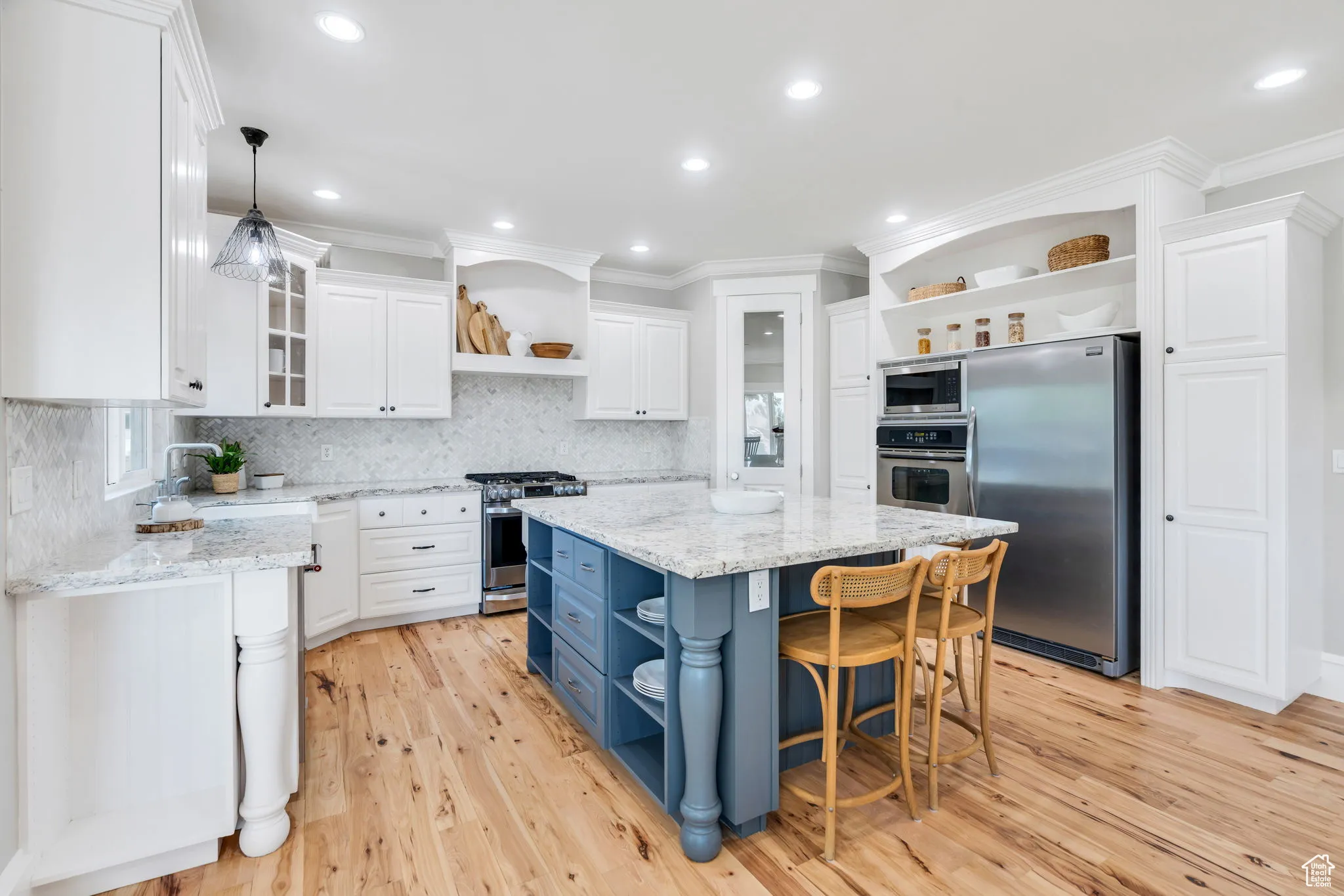 Kitchen featuring open shelves, white cabinetry, light stone counters, stainless steel appliances, and recessed lighting