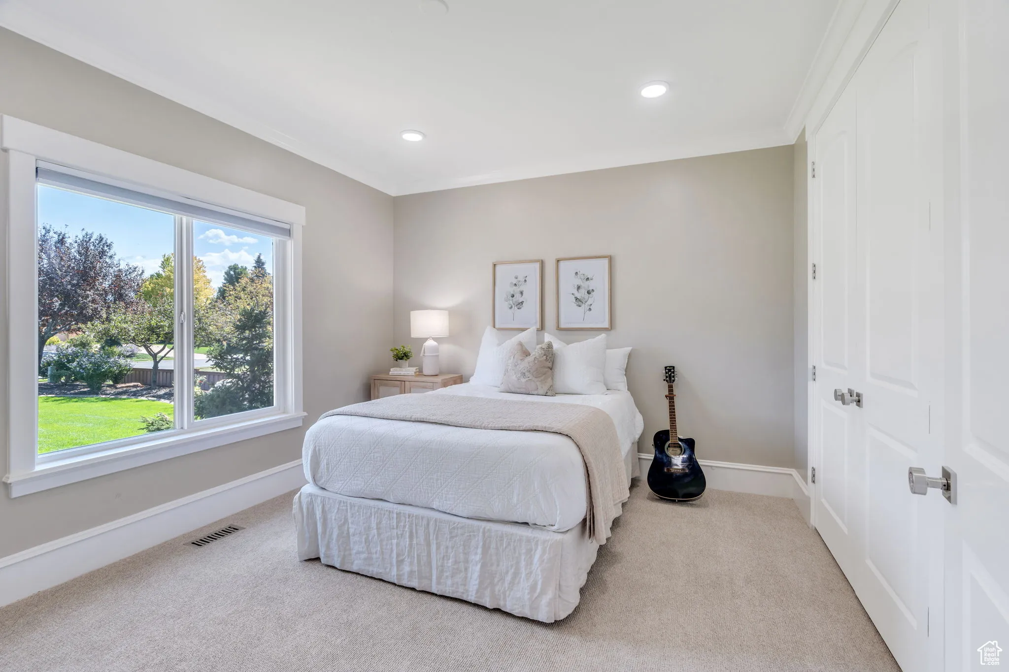 Bedroom featuring light colored carpet, ornamental molding, and recessed lighting