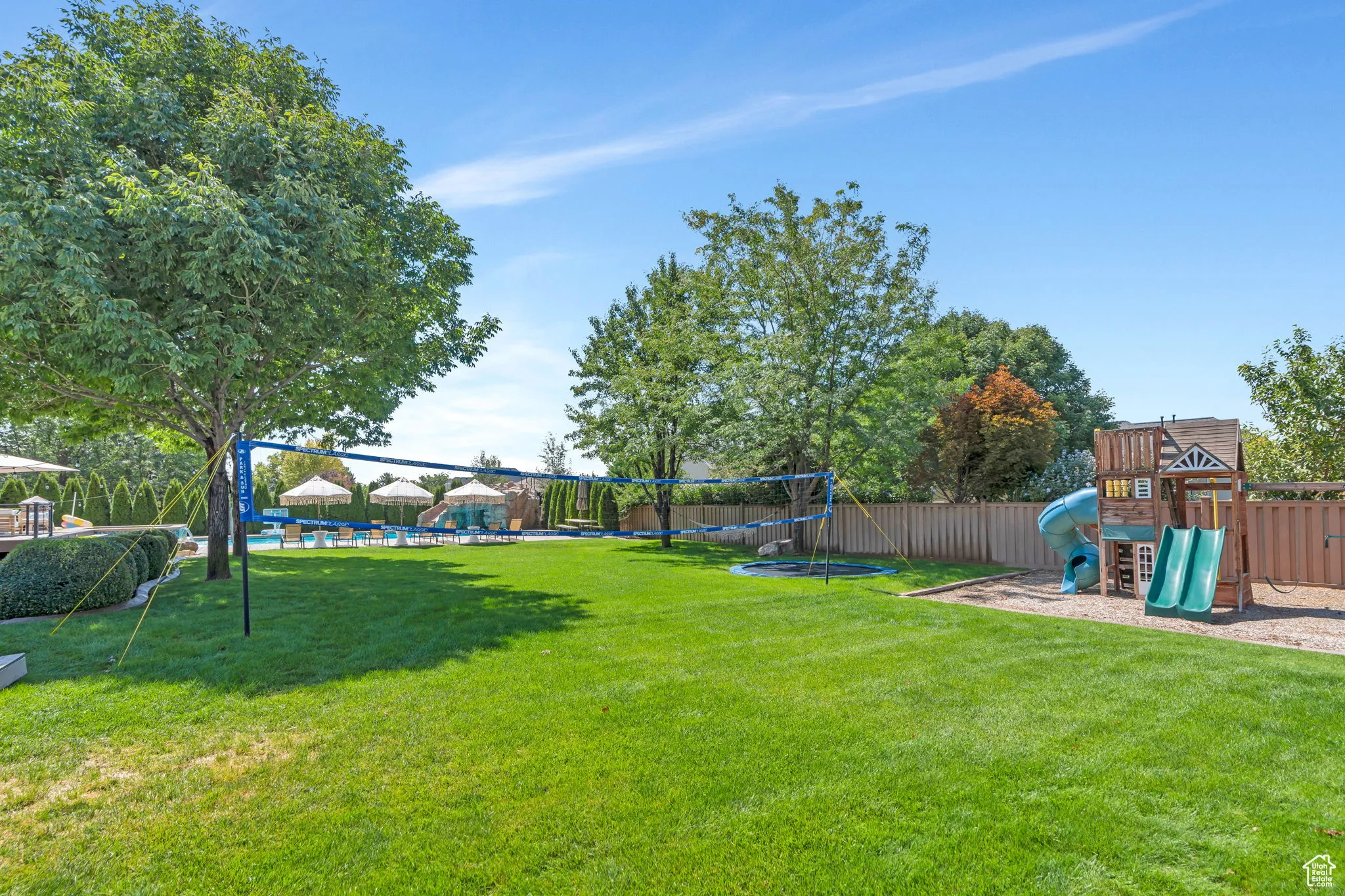 View of yard featuring a playground and a trampoline